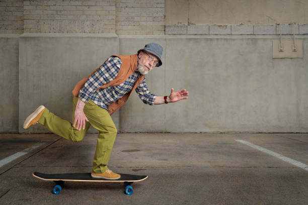 istock senior man riding a long cruising skateboard 1395421246