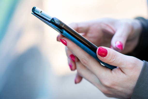 istock Shot of an unrecognizable woman using a mobile phone outdoors. Making a phone call. Crying for help 1395424775
