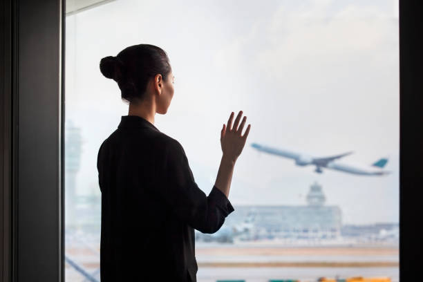 공항 터미널 출발 구역에 서서 비행기로 흔들리는 젊은 중국 여성 - fear airplane flying business travel 뉴스 사진 이미지