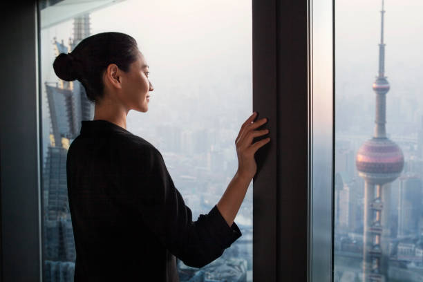 mujer china mirando con orgullo el progreso de la industria inmobiliaria en el centro de la ciudad, shanghai, china - china shanghai business people fotografías e imágenes de stock