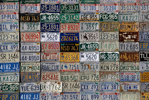 Plain, Montana, USA - June 25, 2009: American license plates of various states on the outside wall of a barn wall.