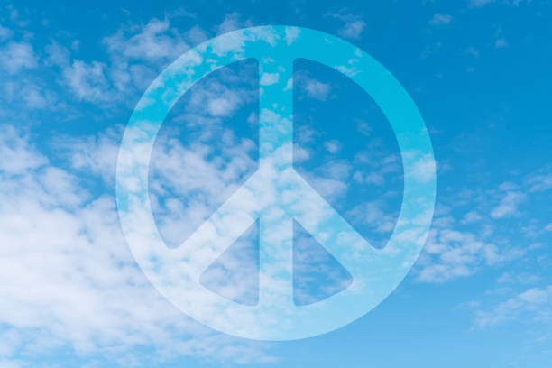 Blue tranquil sky with peace symbol appearing on it. World peace concept.