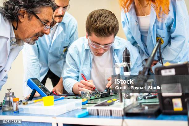 Group Of Young People In Technical Vocational Training With Teacher Stock Photo - Download Image Now