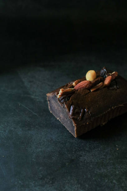 Homemade banana bread with walnut on dark background. Place for text, copy space.
