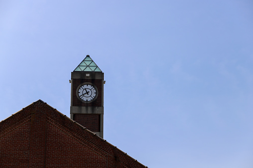 A view of a clock tower against a blue sky