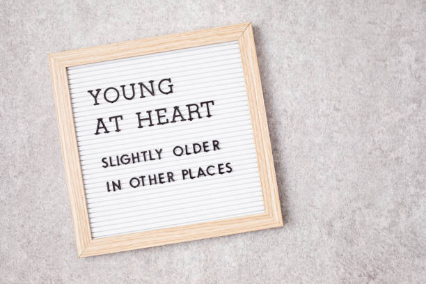 istock Letter board with text young at heart, slightly older in other places 1395433615