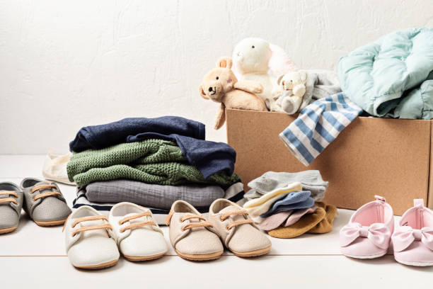 istock Baby and child clothes, toys in box. Second hand apparel idea 1395433628