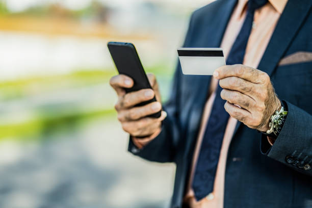 istock Unrecognizable senior businessman using online banking on his smart phone. 1395434470