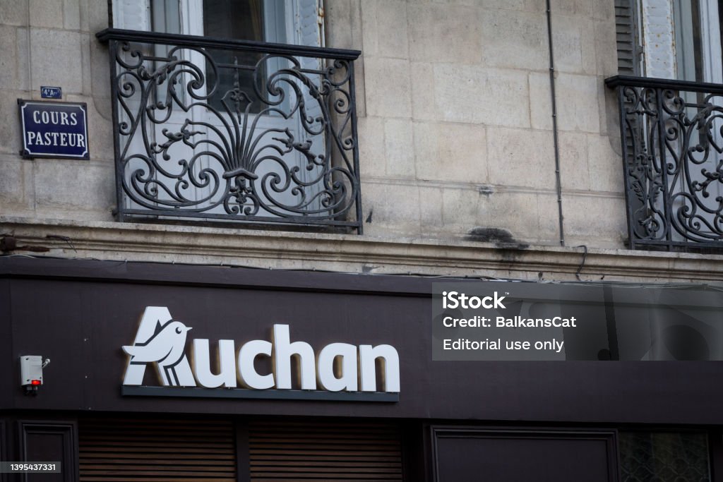 Auchan logo in front of their local supermarket in Bordeux. Auchan is a French retailer of supermarkets and hypermarkets spread in Europe. "n"nPicture of a sign with the logo of Auchan on their local supermarket in Lyon, France. Auchan is a French multinational retail group headquartered in Croix, France. It is a brand of a general commercial French supermarkets Auchan Stock Photo