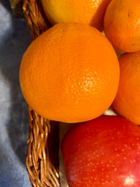 istock Apple and oranges in wicker basket close-up 1395442075