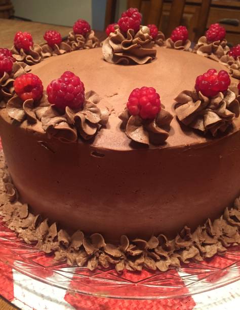 istock Chocolate birthday cake with raspberries 1395442193