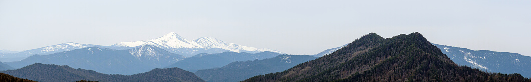 Panorama of mountain peaks covered with snow.
