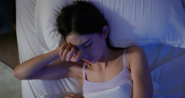asian woman has insomnia Nightmares or depression concept - top view of asian woman takes off eyes cover suffered from insomnia in bedroom at night trouble sleeping stock pictures, royalty-free photos & images