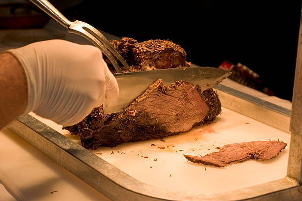 Beef Roast Being Sliced and Served stock photo