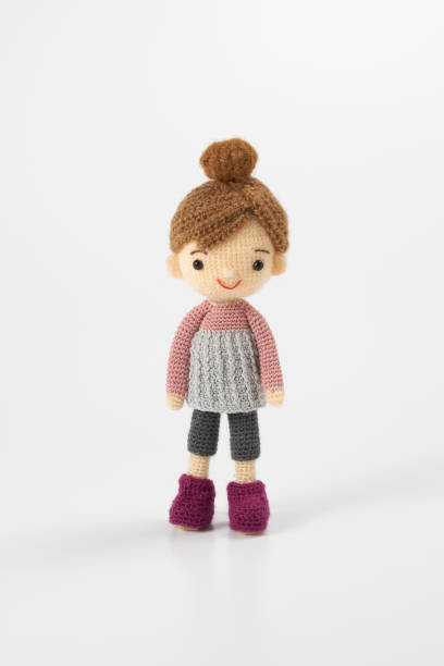 istock Small and cute Amigurumi doll on white background 1395451411
