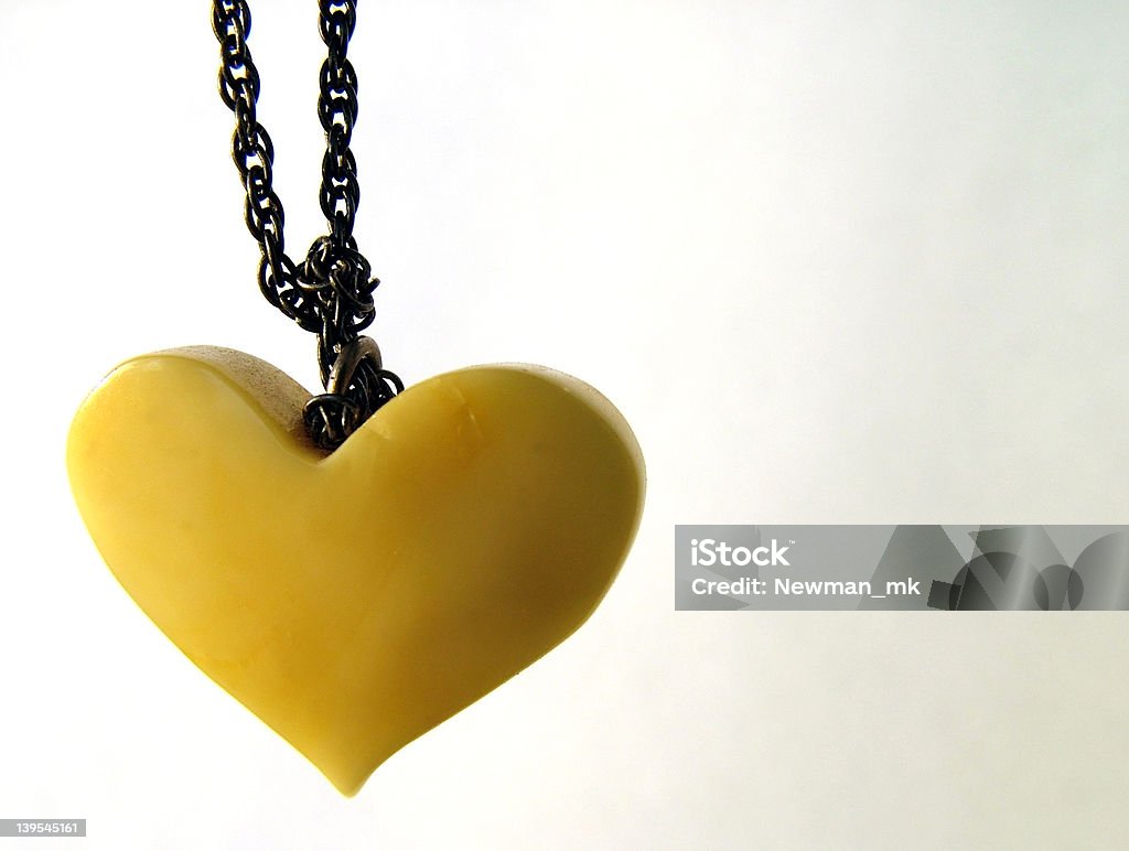 Amber heart Valentine amber heart, close-up, on white background Animal Heart Stock Photo