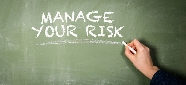 istock Manage Your Risk. Text on a green chalkboard 1395453022