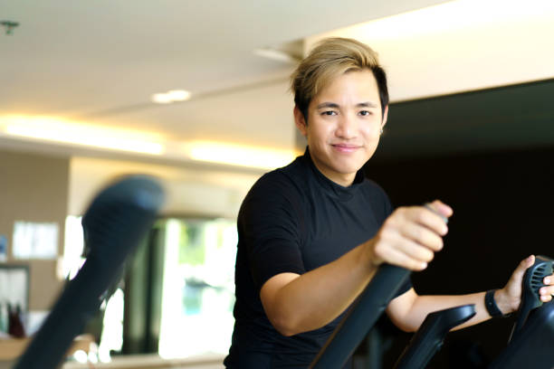 istock Sportsman doing a cardio exercise on elliptical machine. 1395456126