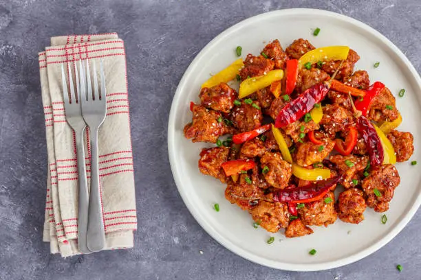 Asian Stir-Fried Chicken With Bell Peppers on a Plate with Fork Top Down Photo