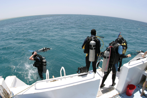 Teenagers having fun snorkeling in their summer vacation