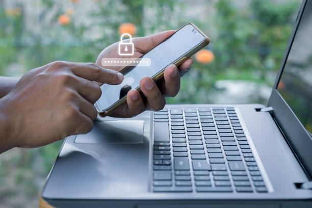 istock Asian businessman using the smart mobile phone to access on phone with laptop for validate password for biometric two steps authentication to unlock security, Business Technology security Concept 1395467477