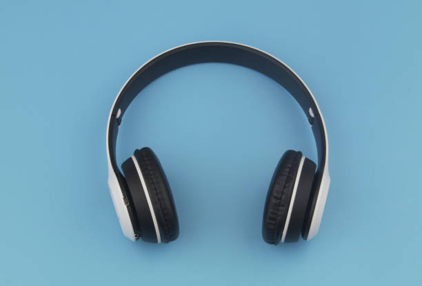 istock Wireless headphones on blue background 1395467767