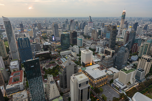 Aerial view of Ploenchit junction with cars traffic skyscraper buildings. Bangkok City in downtown at night, Thailand