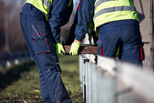 istock Construction maintenance workers working at public site street road. 1395471517