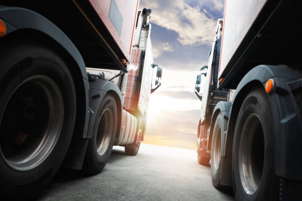 istock Semi TrailerTrucks Parked with Sunset Sky. Shipping Container Trucks. Engine Diesel. Lorry Tractor. Industry Freight Trucks Logistics Cargo Transport. 1395472279