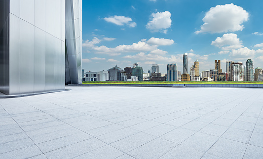Perspective view of empty concrete tiles floor with city skyline, Morning scene