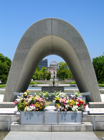 a shot of the memorial, eternal flame and the abomb dome in hiroshima japan, outside the museum.