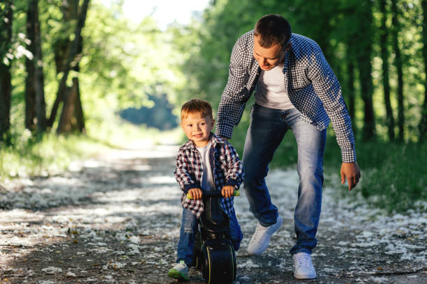 istock The father plays with his son in nature. 1395473885