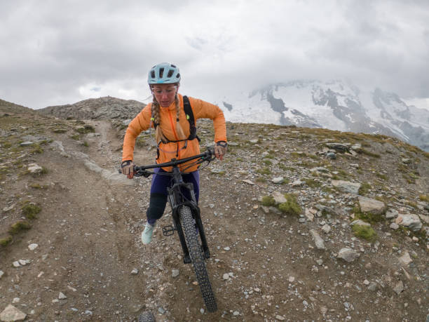 istock Female mountain biker on dirt trail on an overcast day 1395474867