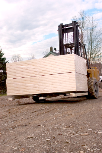 a forklift moving housing supplies