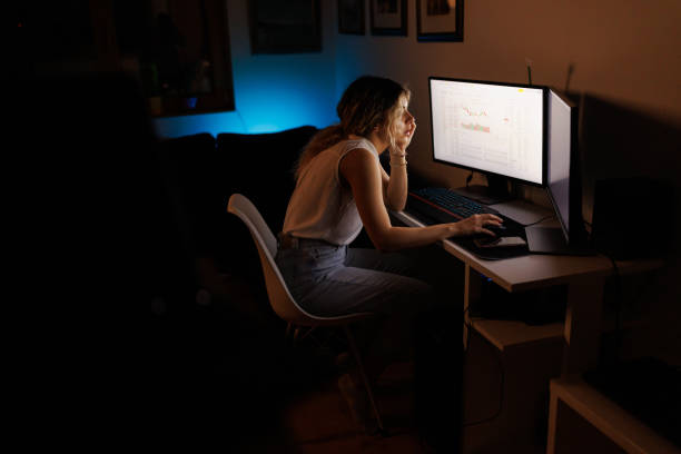 istock Woman working on stock market on computer at night 1395477460