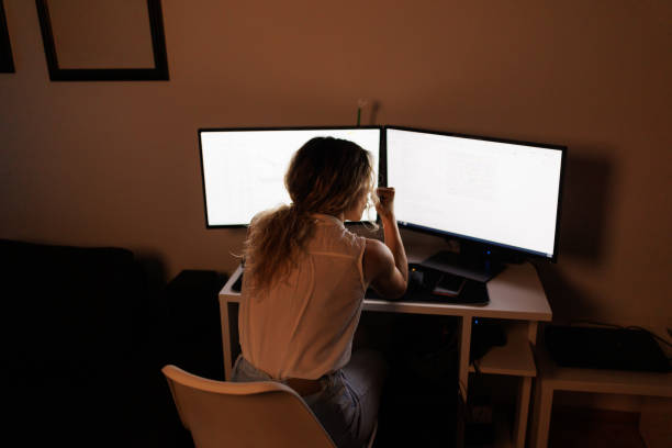 istock Woman working on stock market on computer at night 1395477502