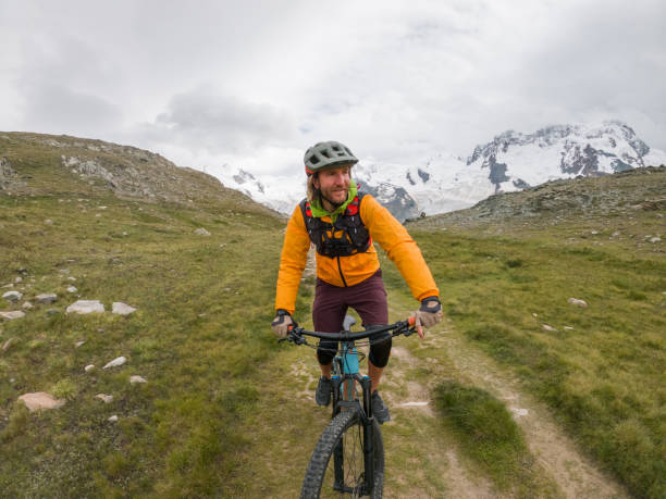 istock Mountain biker on rocky trail, Switzerland 1395477577
