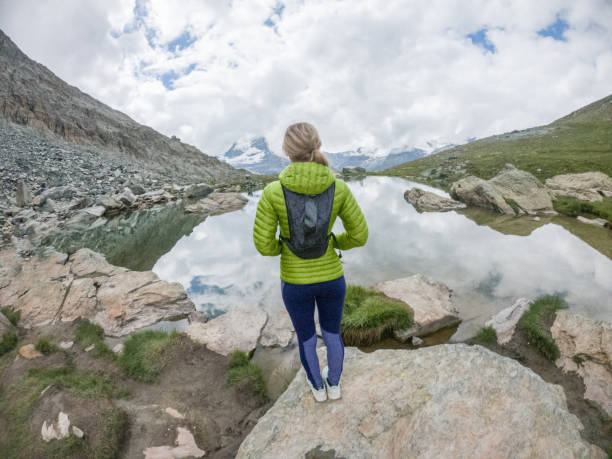 istock Female trail runner looking at view, overcast 1395479178
