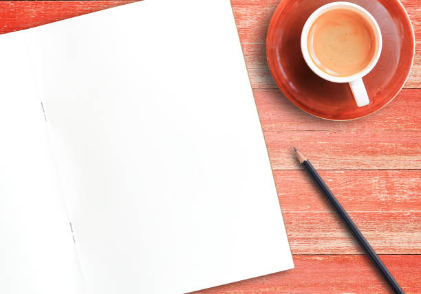 istock blank notebook and coffee on wood table with pencil 1395484420