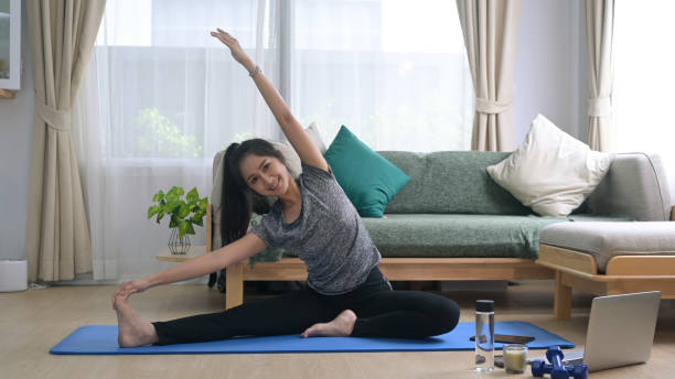 istock Healthy young woman warming up, stretching before workout at home. 1395486684