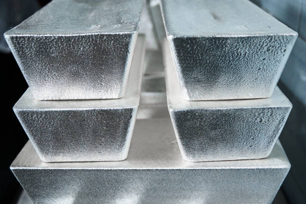 istock Stack of industrial silver ingots at bright light in storage 1395487841