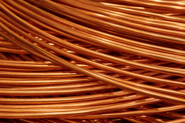 istock Large bobbin of orange copper wire in light warehouse 1395487851
