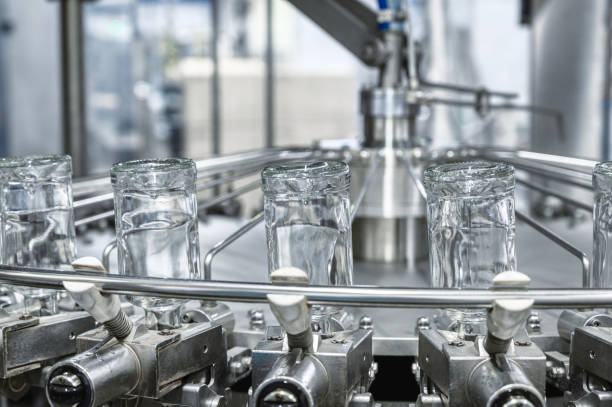 istock Bottles of vodka upside down transported by conveyor 1395488013