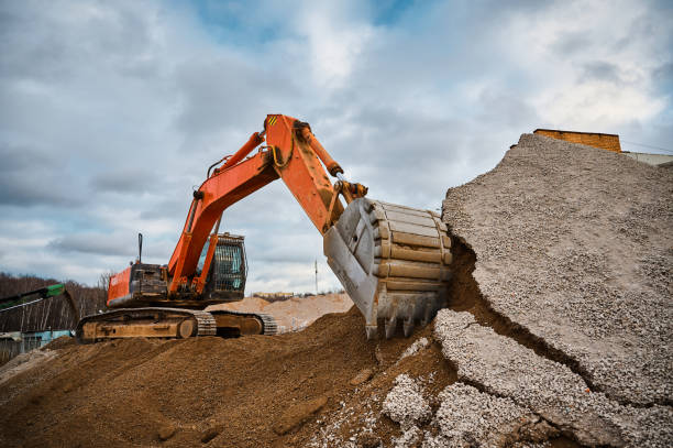 istock Excavator digs soil with bucket at construction site 1395488202
