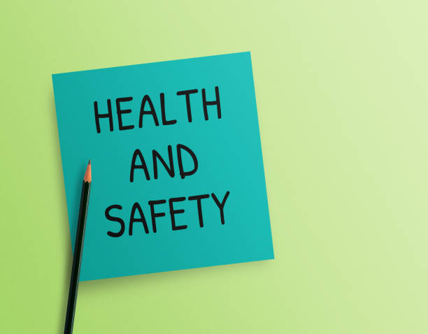 istock Writing note showing Health and Safety on green background. 1395490424