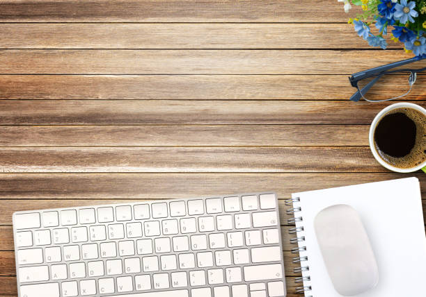 istock Top view with mini wireless keyboard and mouse on brown wood table background. 1395490462