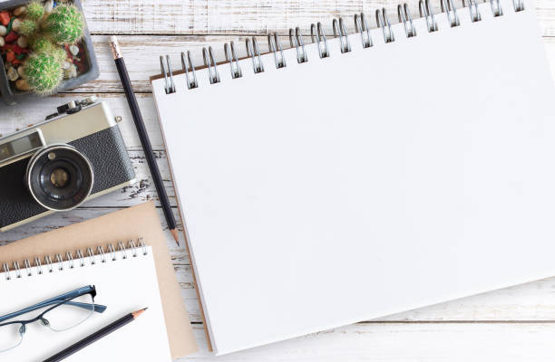 istock Flat lay.Wood office desk table with notebook, cup of coffee and glasses and blank notebook.Top view with copy space 1395490658