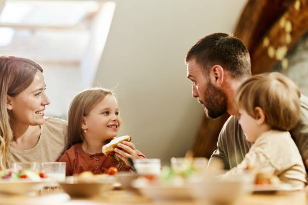 istock Young family talking during breakfast at dining table. 1395490952