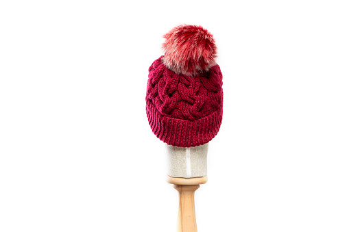 Red knit hat/beanie with mannequin head on white background