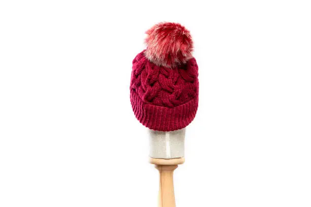 Red knit hat/beanie with mannequin head on white background